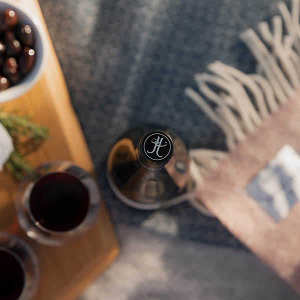 Wine bottle and glasses on a wooden table with a blurred background